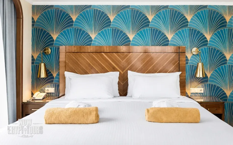 Double cabin with a large bed aboard Radamis I Nile Cruise