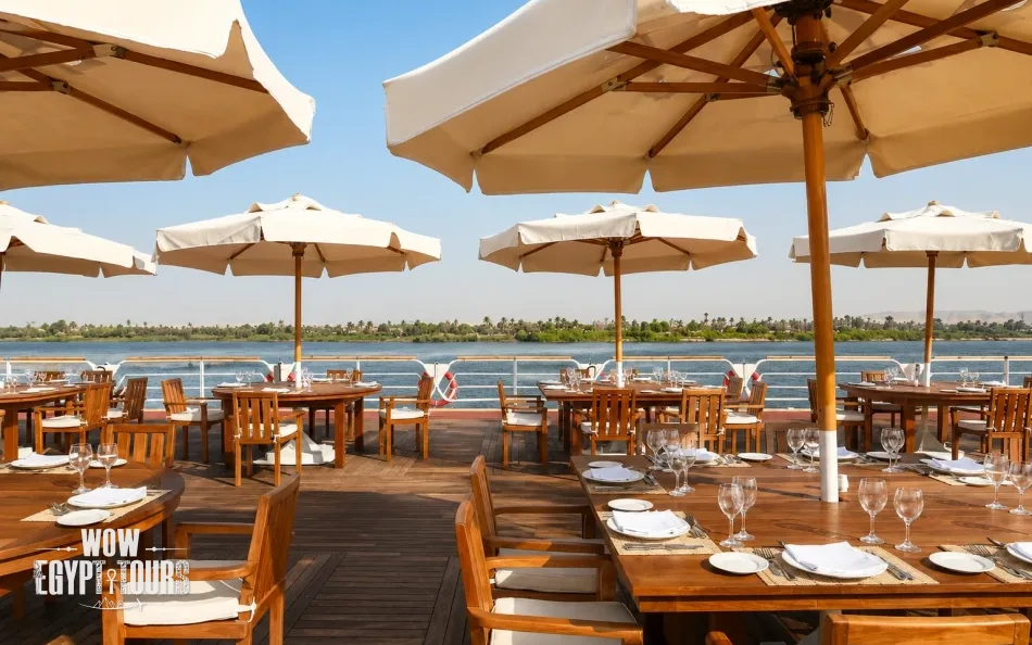 Outdoor sun deck with tables and shaded seating aboard Nile Goddess Nile Cruise