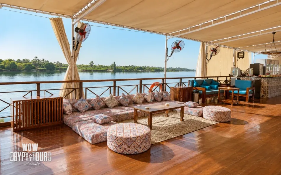 Shaded seating area overlooking the Nile aboard Fatima Dahabiya Nile Cruise