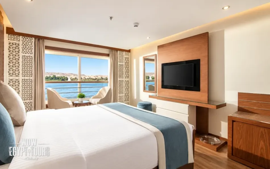 Double cabin with a large bed and Nile River view aboard Nile Capital Nile Cruise