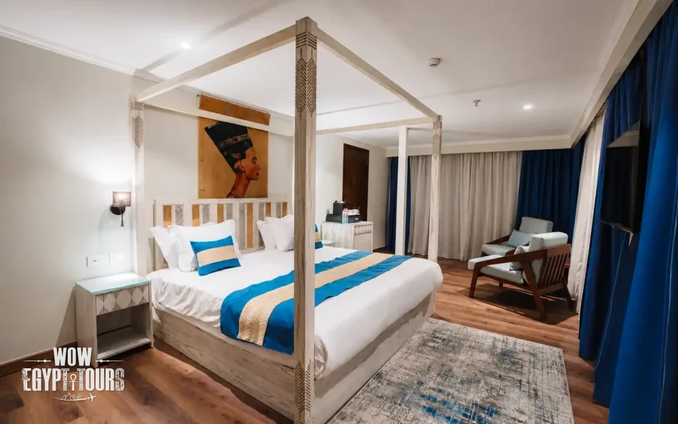 Spacious suite with a large bed aboard Iris Dahabiya Nile Cruise