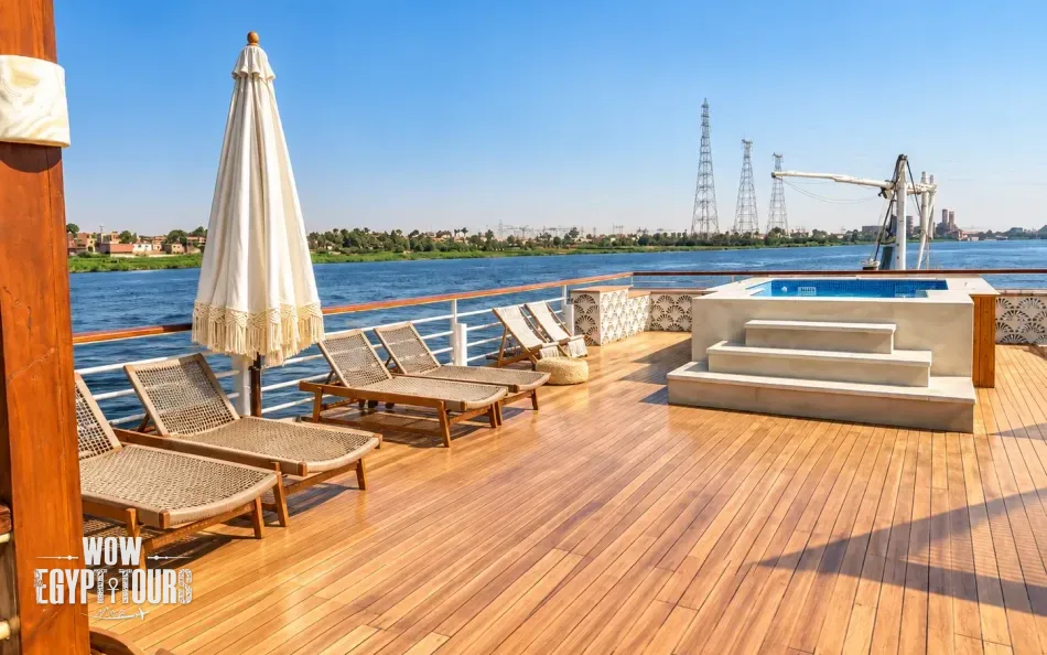 Open sun deck with loungers overlooking the Nile River aboard Per Ba Merkaba Dahabiya Nile Cruise