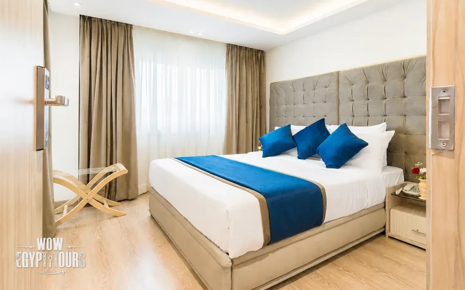Double cabin with a large bed aboard Merit Dahabiya Nile Cruise