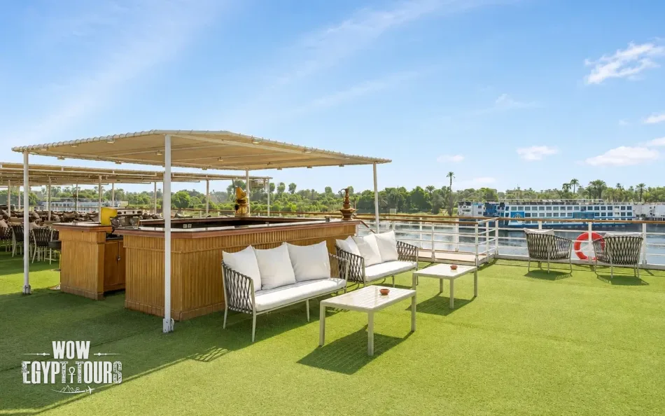 Outdoor sun deck with tables and seating aboard Radamis I Nile Cruise