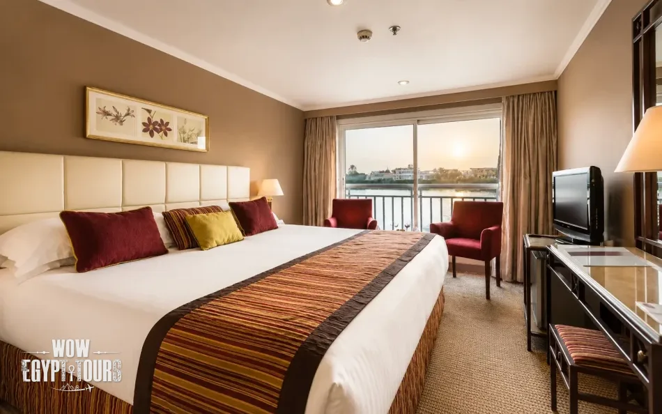 Double cabin with a large bed aboard Jaz Bahareya Nile Cruise