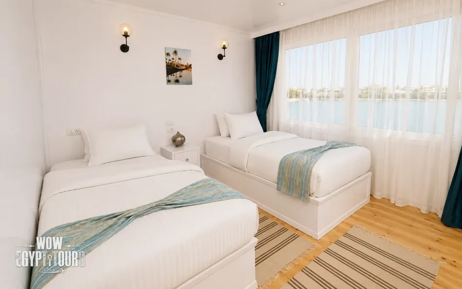 Twin cabin with two separate beds and Nile views aboard Turquoise Dahabiya Nile Cruise