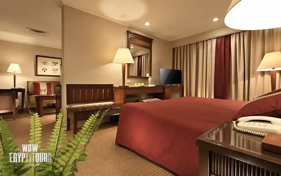 Spacious suite with seating area aboard Jaz Crown Empress Nile Cruise