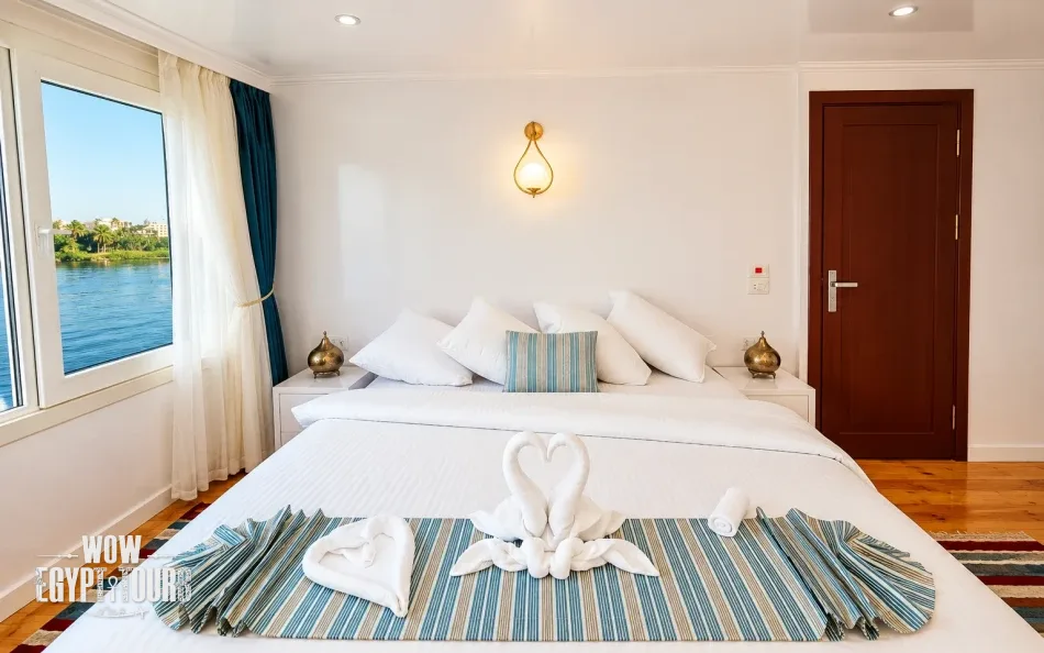 Double cabin with a large bed aboard Turquoise Dahabiya Nile Cruise