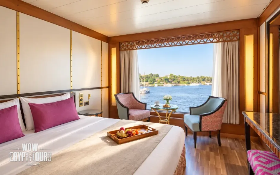 Double cabin with a large bed and Nile River view aboard Alyssa Nile Cruise