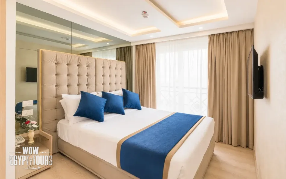 Spacious suite with a large bed aboard Merit Dahabiya Nile Cruise