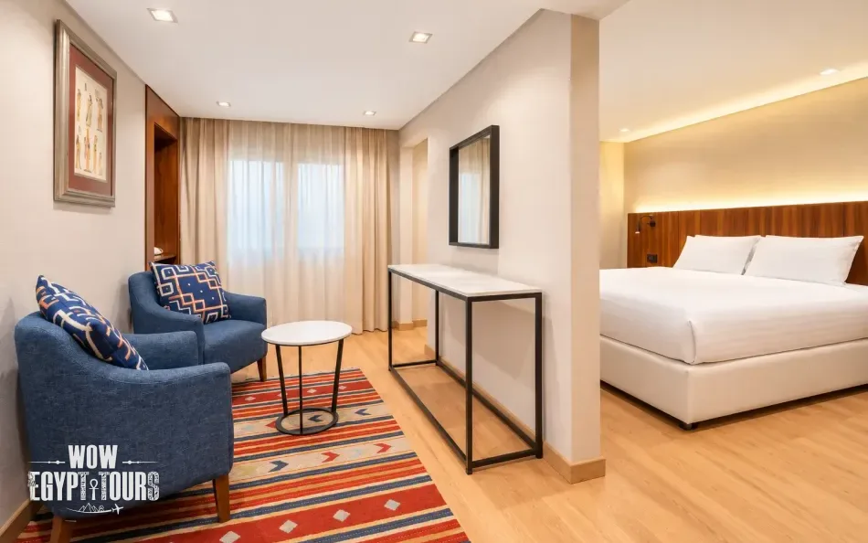 Spacious suite with bedroom and seating area aboard Nile Plaza Nile Cruise