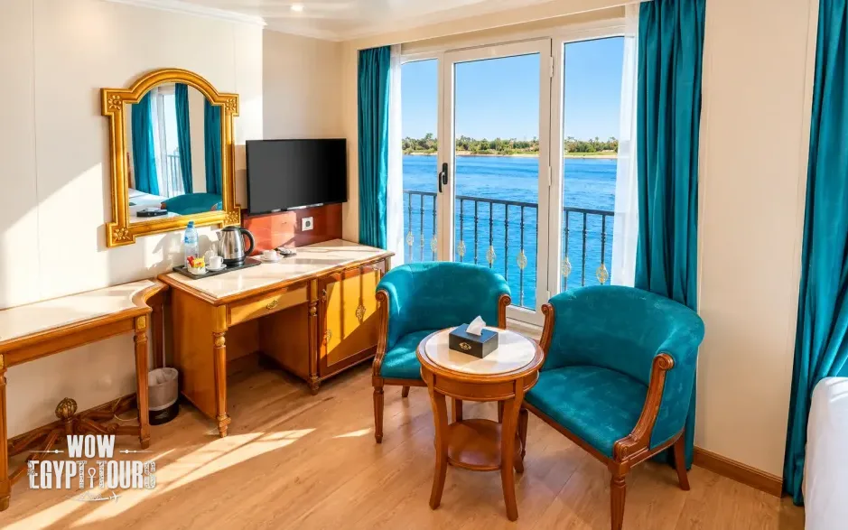 Cabin interior with seating area and Nile River views aboard Nile Quest Nile Cruise
