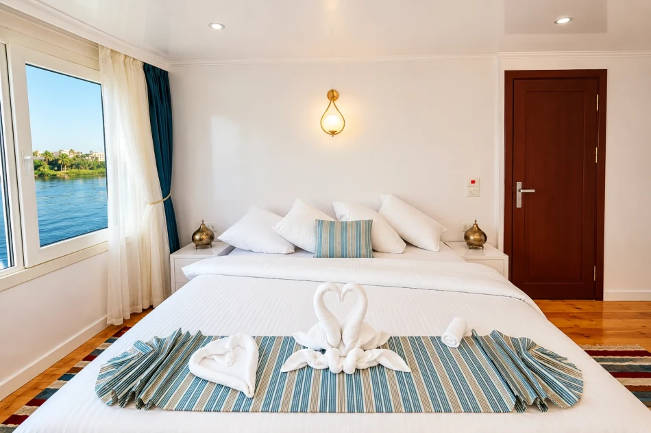 Double cabin with a large bed aboard Turquoise Dahabiya Nile Cruise