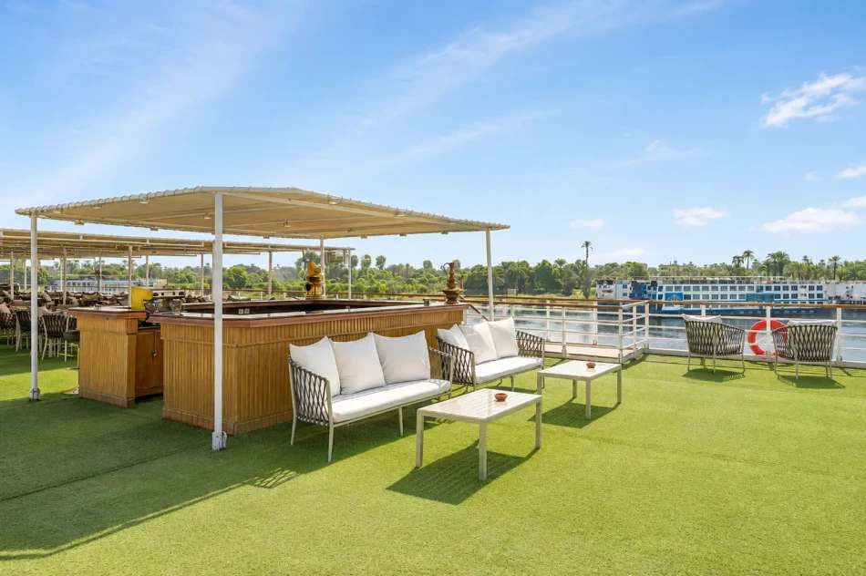 Outdoor sun deck with tables and seating aboard Radamis I Nile Cruise