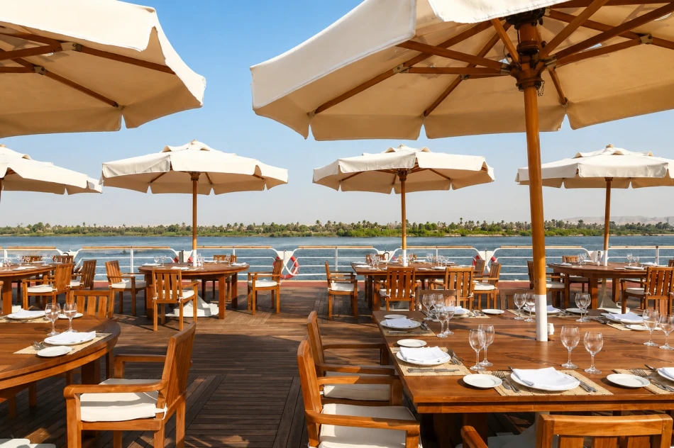 Outdoor sun deck with tables and shaded seating aboard Nile Goddess Nile Cruise