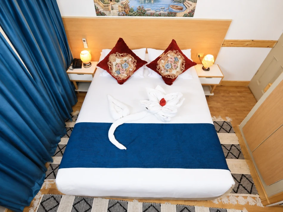 Double cabin with a large bed aboard Gorgonia Dahabiya Nile Cruise