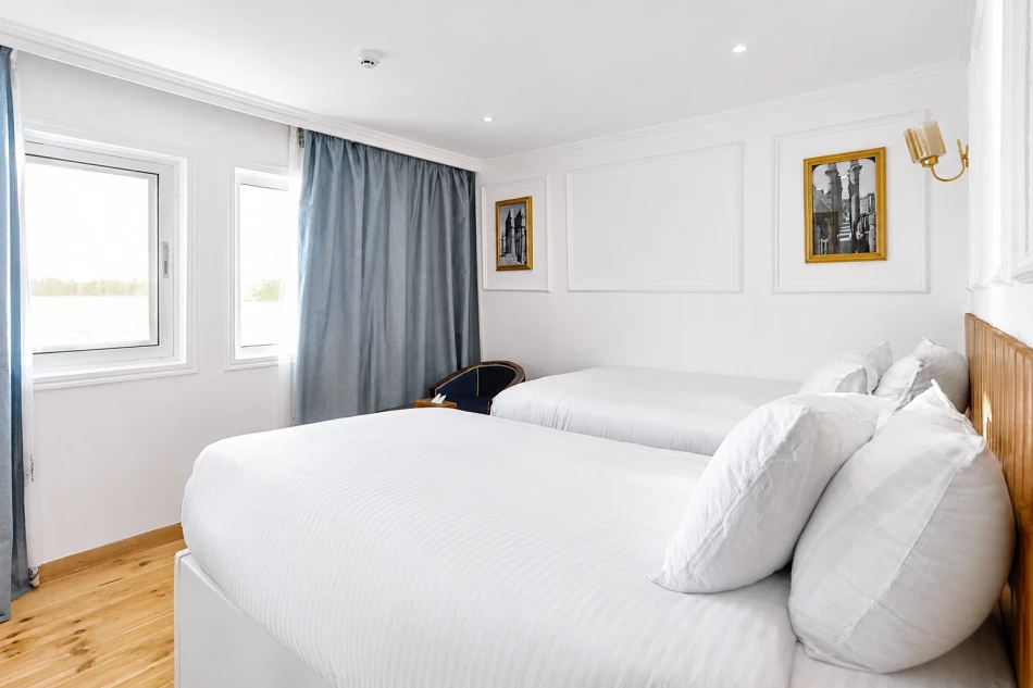 Double cabin with a large bed aboard Fatima Dahabiya Nile Cruise