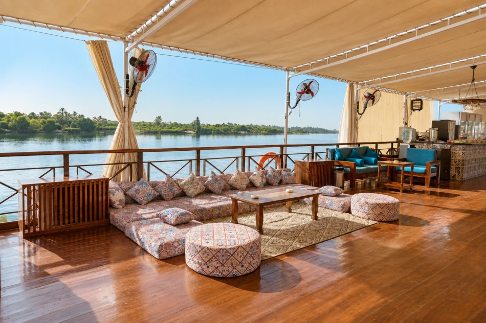 Shaded seating area overlooking the Nile aboard Fatima Dahabiya Nile Cruise