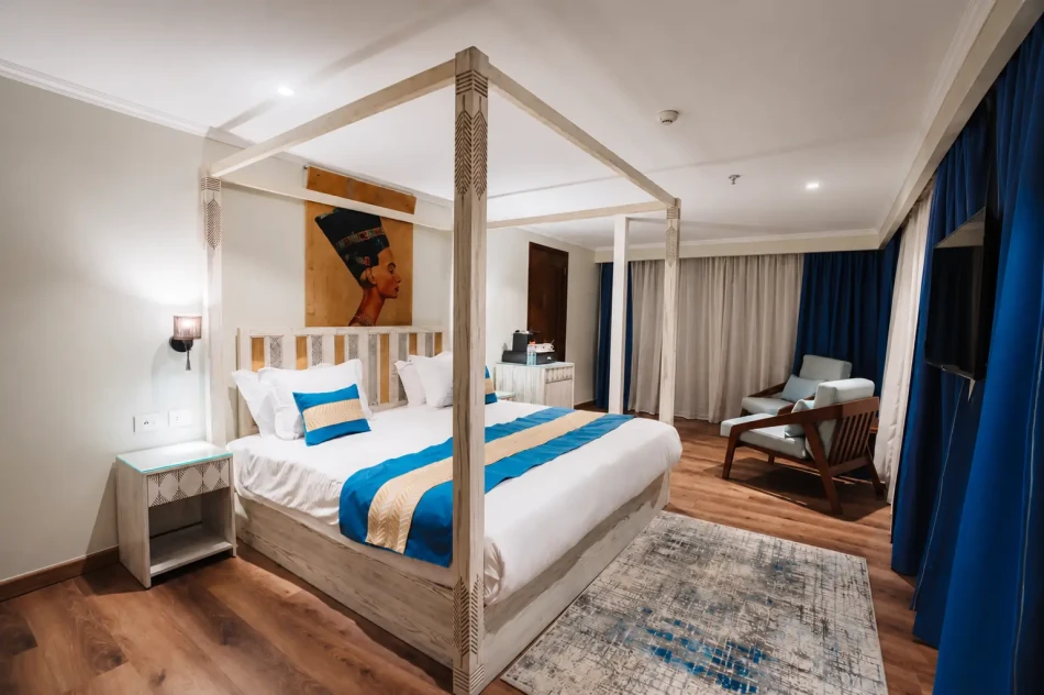 Spacious suite with a large bed aboard Iris Dahabiya Nile Cruise