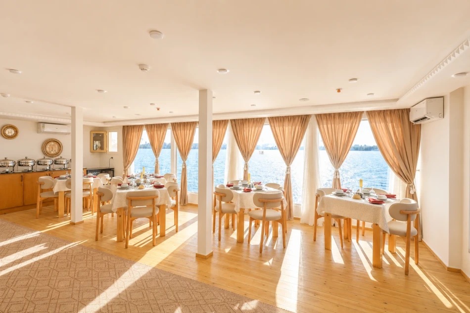 Dining area with tables and seating aboard Sila Dahabiya Nile Cruise
