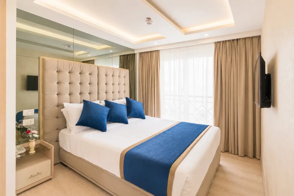 Spacious suite with a large bed aboard Merit Dahabiya Nile Cruise