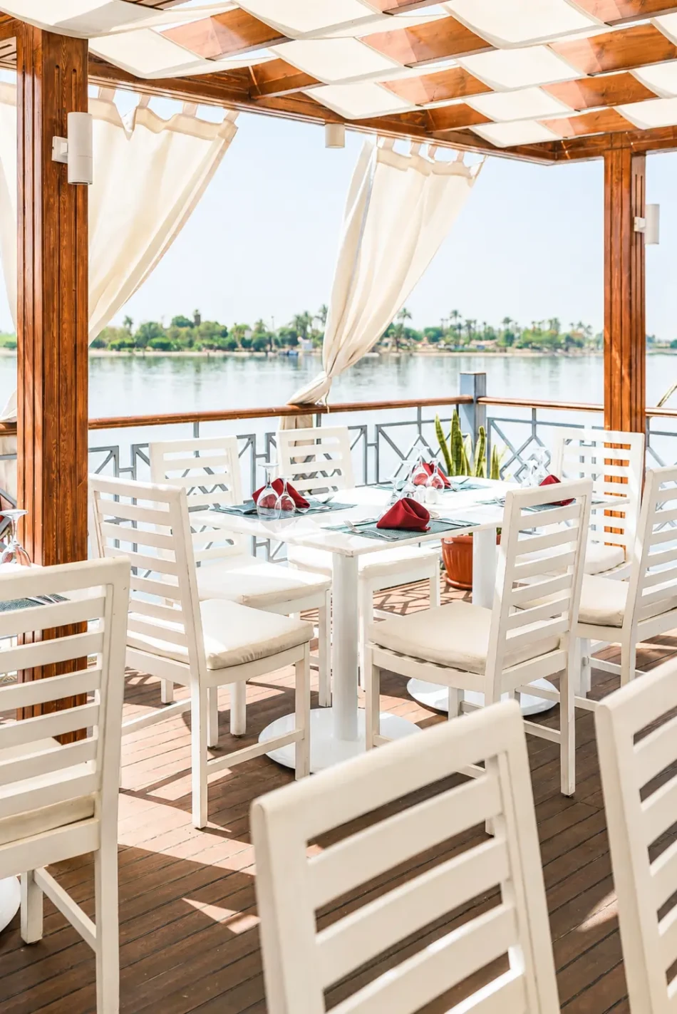 Open-air dining area overlooking the Nile aboard Merit Dahabiya Nile Cruise