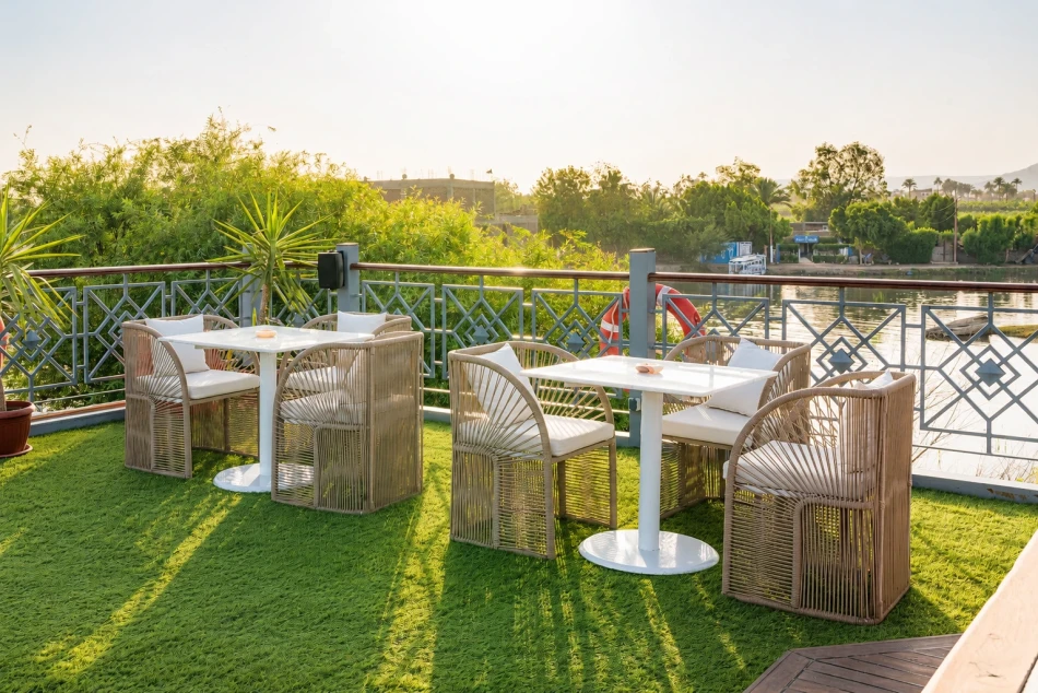 Outdoor dining tables on the sun deck of Merit Dahabiya Nile Cruise